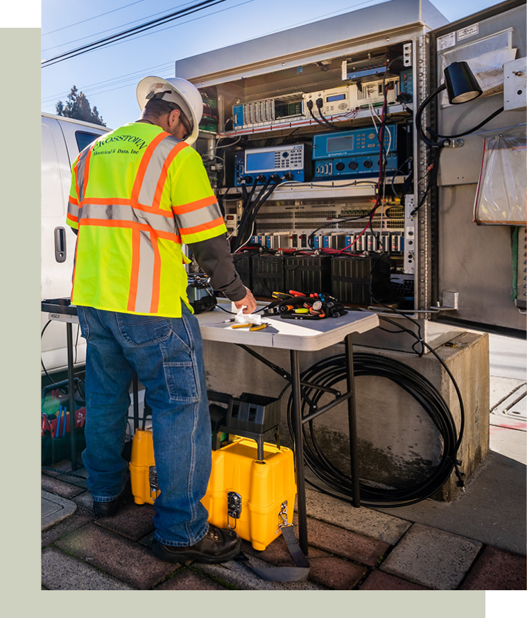 Electrical Contractor in front of equipment